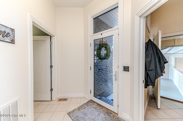 doorway featuring light tile patterned flooring