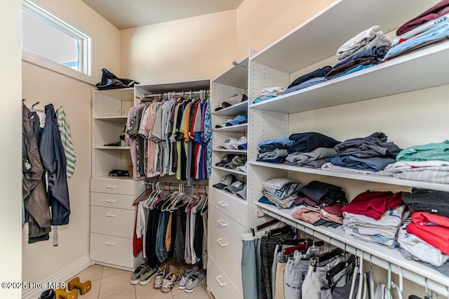 spacious closet with light tile patterned floors