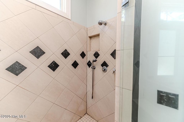 bathroom with tiled shower