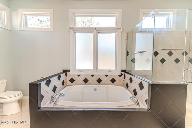 bathroom featuring tile patterned floors, toilet, and shower with separate bathtub