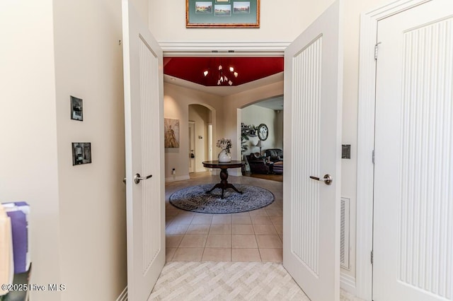 hall featuring light tile patterned flooring