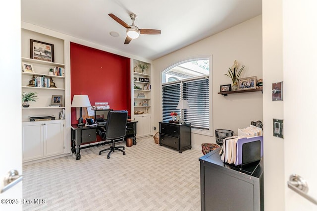 office space featuring ceiling fan and light carpet