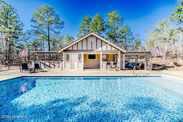 view of swimming pool featuring an outdoor structure and a patio