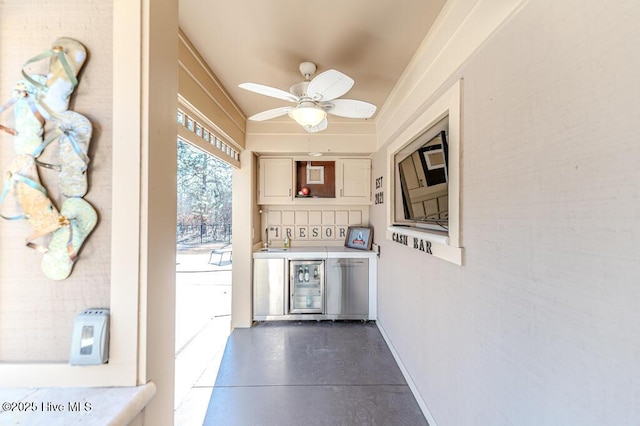 interior space featuring wine cooler, ceiling fan, and sink