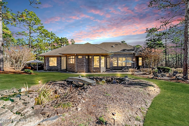 view of front of property with a lawn and a patio area