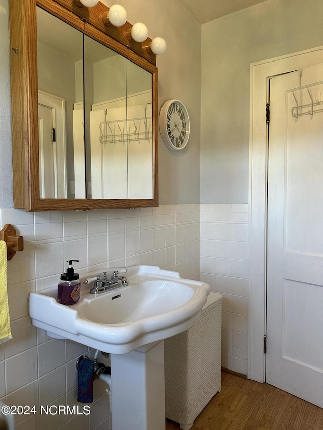 bathroom featuring hardwood / wood-style flooring and tile walls