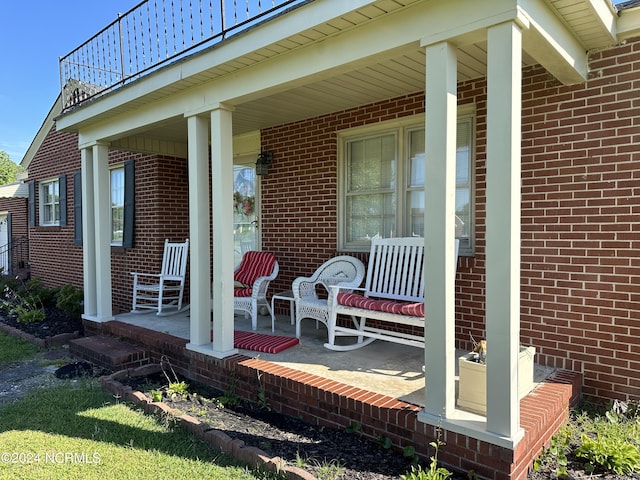 view of patio / terrace featuring covered porch and a balcony