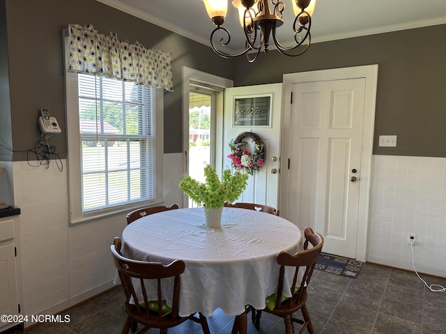 dining area featuring crown molding, tile walls, and a notable chandelier