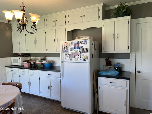 kitchen with white appliances, an inviting chandelier, white cabinetry, and ornamental molding