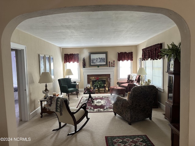 carpeted living room featuring a fireplace