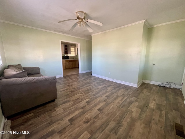 living room with ornamental molding, ceiling fan, and dark wood-type flooring