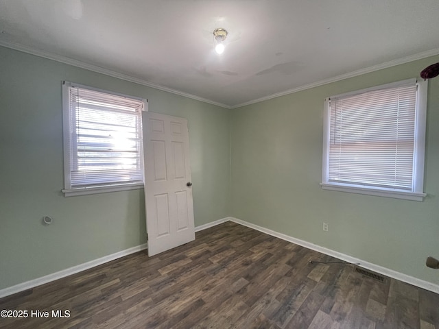 unfurnished room with dark hardwood / wood-style floors and crown molding