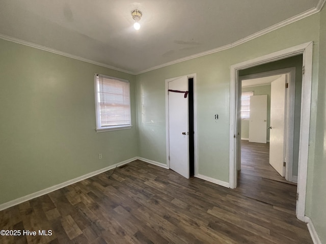 unfurnished bedroom featuring dark hardwood / wood-style floors, crown molding, and a closet