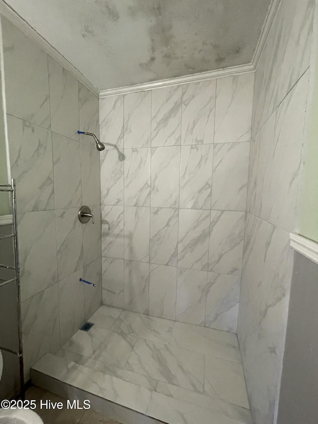 bathroom with a tile shower