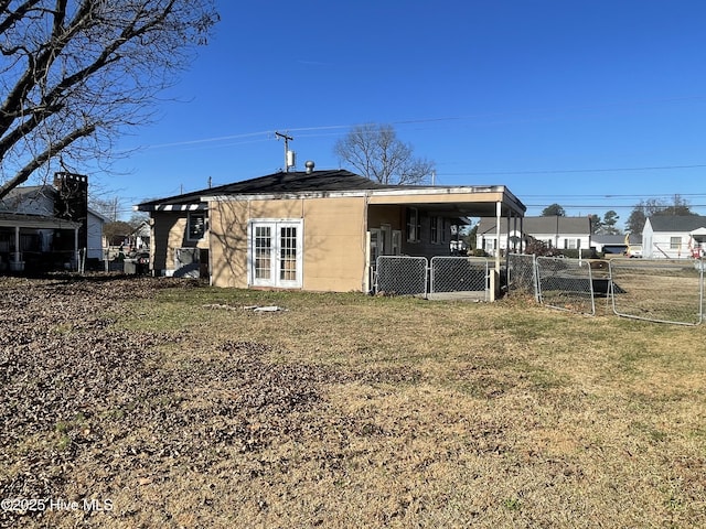 rear view of property with a lawn