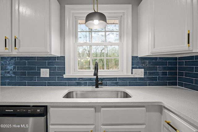 kitchen with white cabinetry, decorative backsplash, stainless steel dishwasher, sink, and pendant lighting