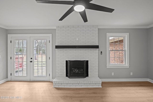 unfurnished living room featuring crown molding, a brick fireplace, and a wealth of natural light