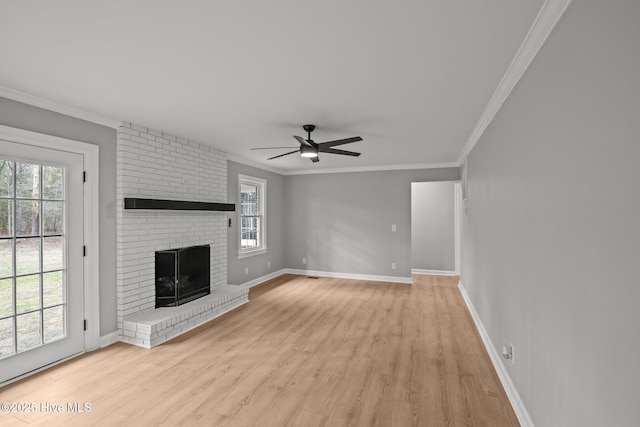 unfurnished living room featuring a fireplace, light hardwood / wood-style floors, ceiling fan, and crown molding