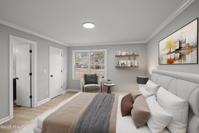 bedroom with crown molding and light hardwood / wood-style flooring