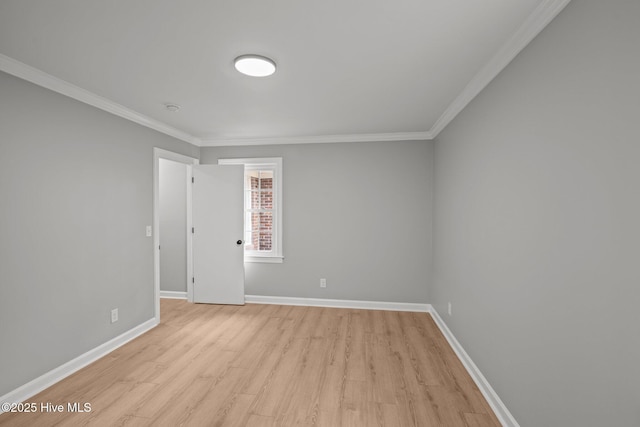 empty room featuring light hardwood / wood-style flooring and crown molding