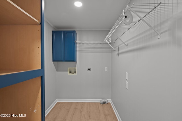 laundry room with crown molding, hookup for an electric dryer, light wood-type flooring, cabinets, and washer hookup