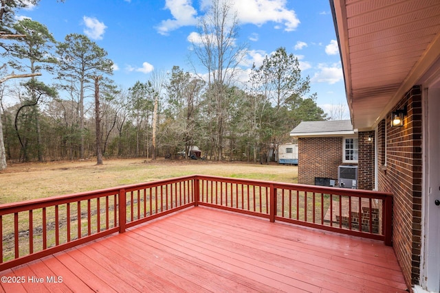 wooden terrace with a lawn