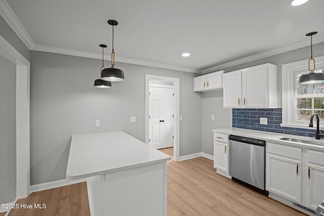 kitchen with stainless steel dishwasher, sink, decorative light fixtures, white cabinetry, and decorative backsplash