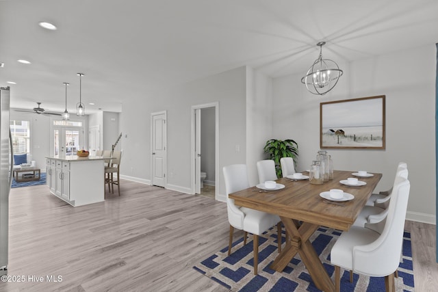 dining room featuring a chandelier and light hardwood / wood-style flooring