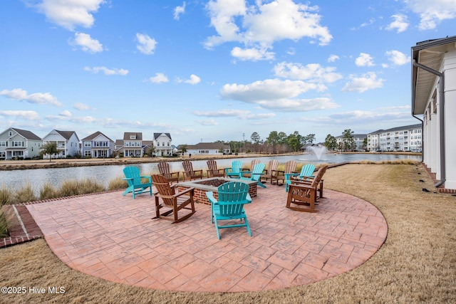 view of patio with a water view and an outdoor fire pit