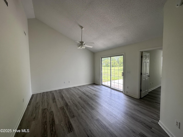 empty room with a textured ceiling, ceiling fan, dark hardwood / wood-style floors, and lofted ceiling