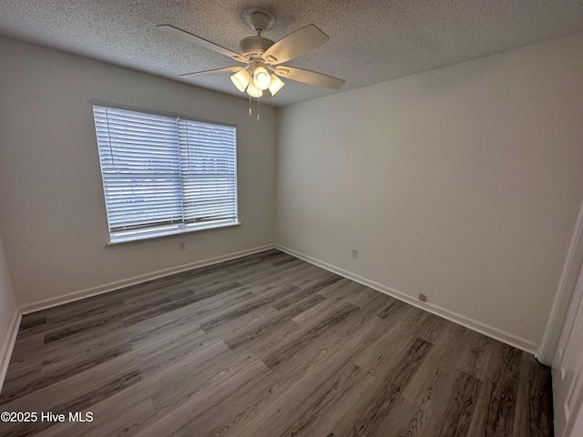 spare room featuring a textured ceiling, dark hardwood / wood-style flooring, and ceiling fan