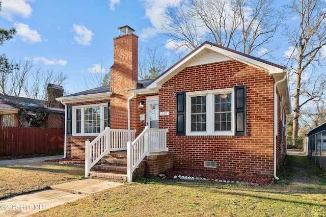 bungalow-style house featuring a front yard