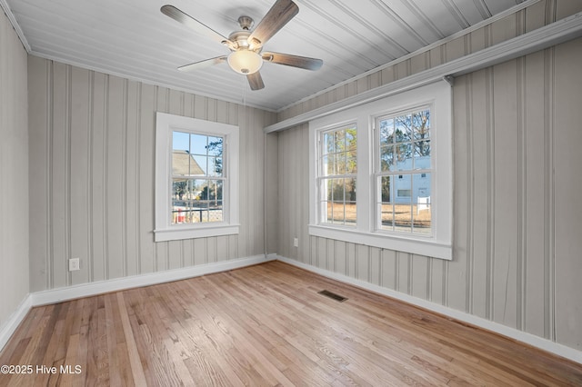 empty room with ceiling fan and light wood-type flooring