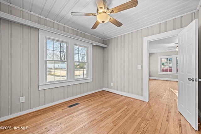 spare room featuring light hardwood / wood-style flooring and plenty of natural light