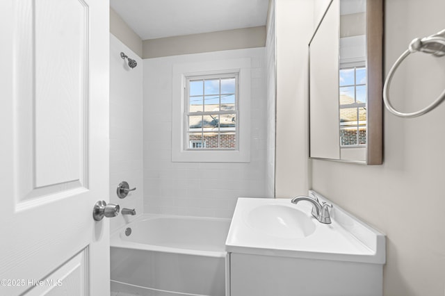 bathroom featuring vanity, a wealth of natural light, and tiled shower / bath combo