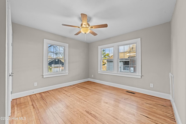 spare room featuring light hardwood / wood-style flooring, plenty of natural light, and ceiling fan