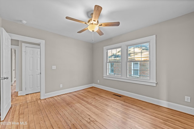 spare room featuring light wood-type flooring and ceiling fan