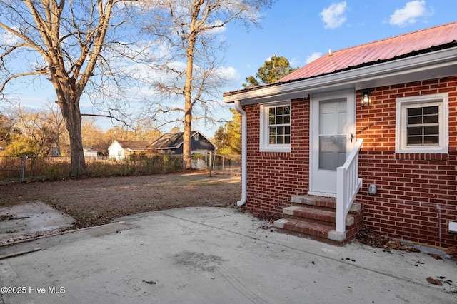 property entrance featuring a patio area