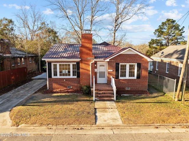 bungalow-style home with a front yard