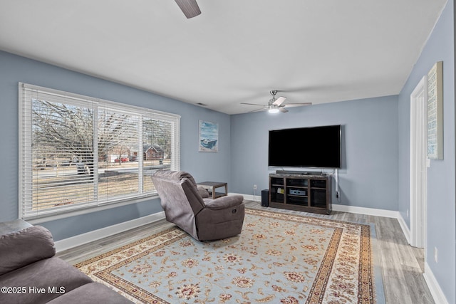 living room featuring hardwood / wood-style flooring and ceiling fan