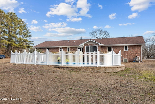 back of house featuring a pool, a yard, and central AC