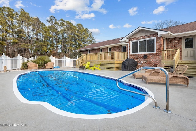 view of pool featuring a patio and a deck