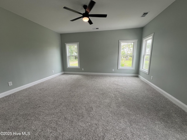 carpeted spare room with ceiling fan and a healthy amount of sunlight