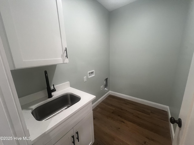 laundry room featuring sink, cabinets, dark wood-type flooring, hookup for an electric dryer, and hookup for a washing machine