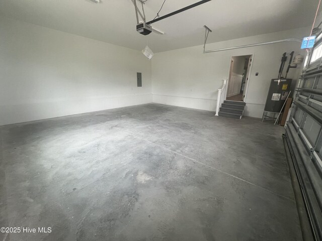 garage featuring electric panel, gas water heater, and a garage door opener