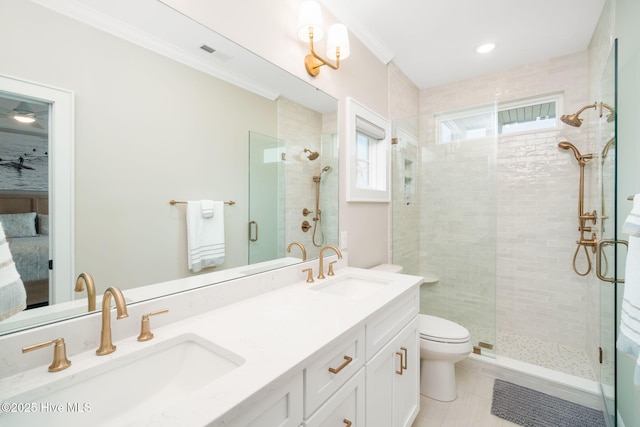 bathroom with tile patterned floors, toilet, an enclosed shower, crown molding, and vanity