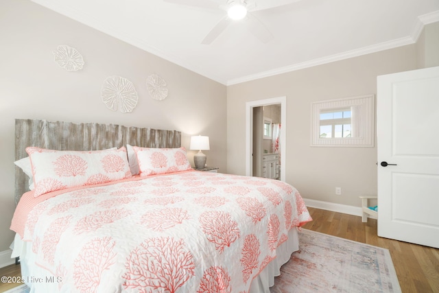 bedroom with crown molding, connected bathroom, ceiling fan, and light hardwood / wood-style flooring