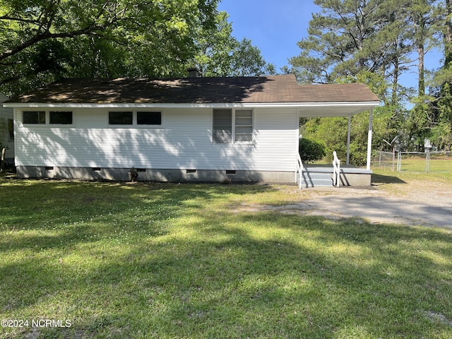 rear view of property with a yard