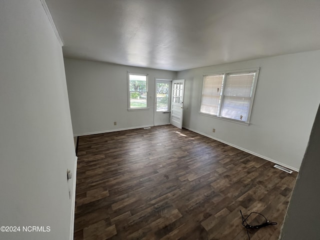 spare room with dark hardwood / wood-style floors