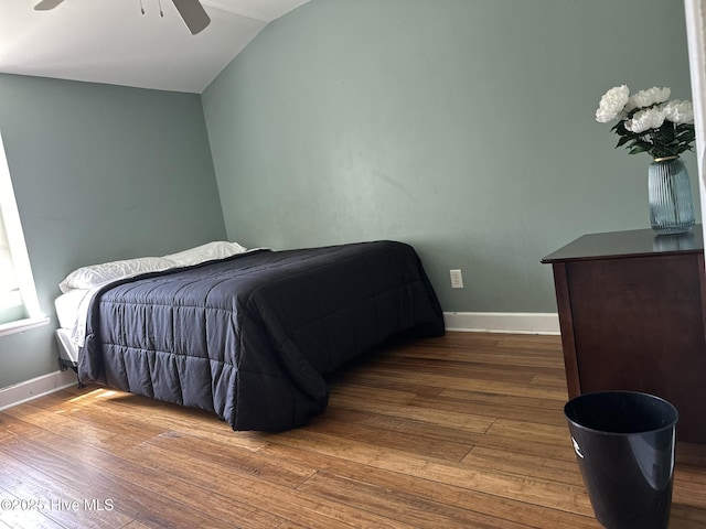 bedroom with ceiling fan, lofted ceiling, and hardwood / wood-style flooring